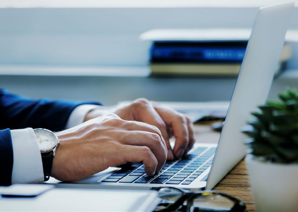 Business Man Typing on Laptop